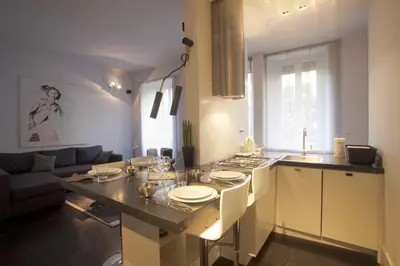 a kitchen with a table with plates on it at Vatican Modern Apartment in Rome