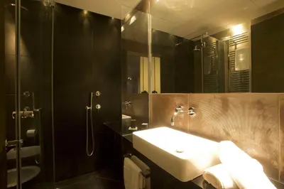 a bathroom with a sink and a mirror at Vatican Modern Apartment in Rome