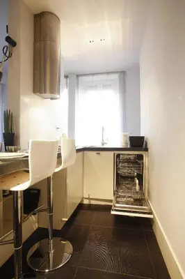 a kitchen with a table and chairs and a window at Vatican Modern Apartment in Rome