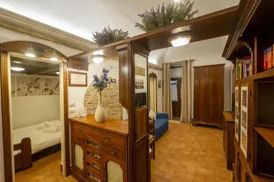 a bedroom with a bed and a dresser with a mirror at Romantic Piazza Navona Hideaway in Rome