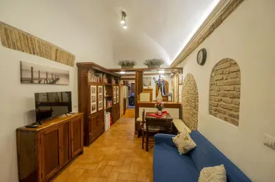 a blue tiled bathroom with a sink and a mirror at Romantic Piazza Navona Hideaway in Rome