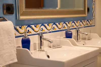 a bathroom with three sinks and a mirror at La Casa Del Pigneto in Rome