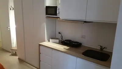 a kitchen with a counter top with a microwave at La Casetta di Ely in Rome