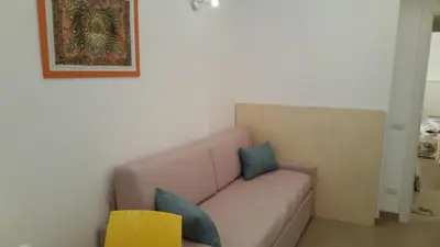 a living room with a couch with blue pillows at La Casetta di Ely in Rome