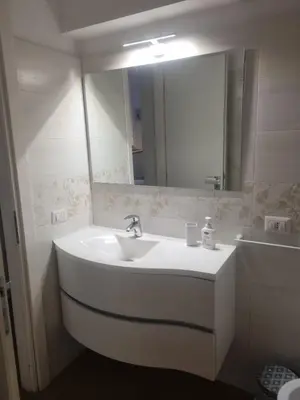 a bathroom with a white sink and a mirror at La Casetta di Ely in Rome