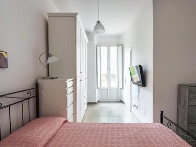 a bedroom with a bed and a television and a hallway at Apartment Il Piccolo by Interhome in Rome
