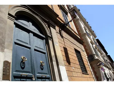 a blue door on the side of a building at Apartment Via Giulia in Rome
