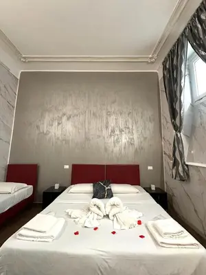 a bedroom with a bed with red roses on it at Il Tempio Della Capitale in Rome