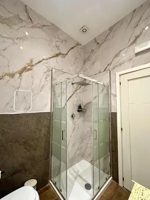 a bathroom with a sink and a marble wall at Il Tempio Della Capitale in Rome