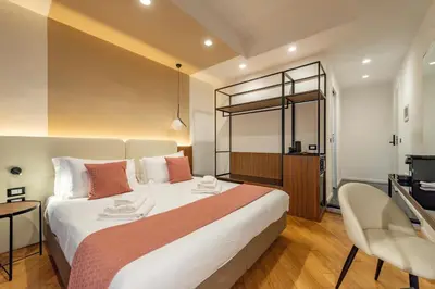a hotel room with a large bed and a television at Relais Pamphili guest house by Ghor in Rome