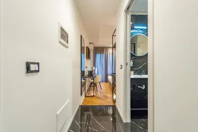 a hallway leading to a living room with a sink at Relais Pamphili guest house by Ghor in Rome