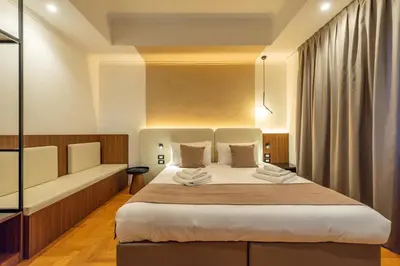 a bedroom with a large bed and a couch at Relais Pamphili guest house by Ghor in Rome