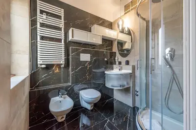 a bathroom with a toilet and a sink and a shower at Relais Pamphili guest house by Ghor in Rome