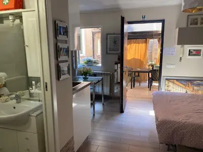 a small kitchen with a sink and a counter at Condotti Apartment in Rome