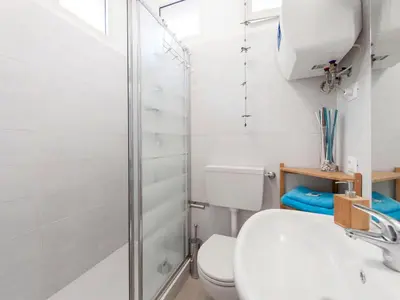 a bathroom with a shower and a toilet and a sink at Condotti Apartment in Rome
