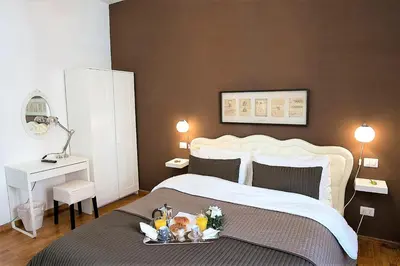 a bedroom with a bed with a tray of food on it at Capone Al Vaticano in Rome