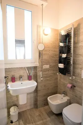 a bathroom with a sink and a toilet and a window at Capone Al Vaticano in Rome