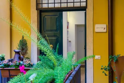 a green door on a building with plants and flowers at Zefiro Home in Rome