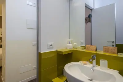 a bathroom with a sink and a mirror at Zefiro Home in Rome