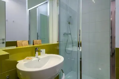 a bathroom with a sink and a glass shower at Zefiro Home in Rome