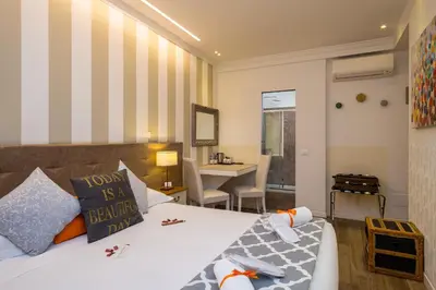 a bedroom with a bed and a table with a desk at Zefiro Home in Rome