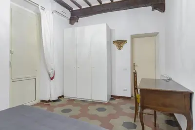 a room with a desk and a table and two doors at Navona Family Apartment in Rome