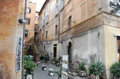 an alley in an old building with potted plants at Navona Family Apartment in Rome