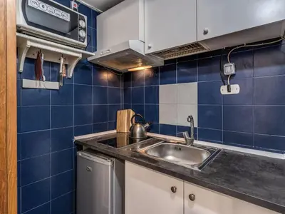 a small kitchen with a sink and blue tiles at Apartment Wohnung mit Wi-Fi by Interhome in Rome