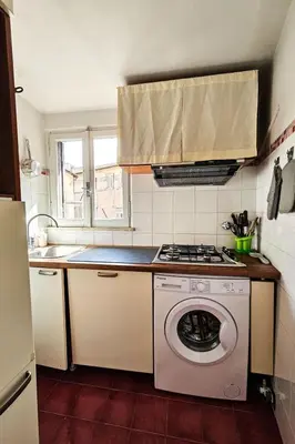 a kitchen with a washing machine and a stove at Apartment Wohnung Monserrato by Interhome in Rome