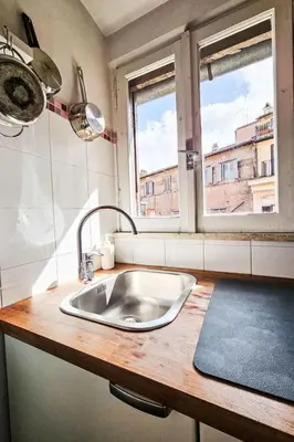 a kitchen counter with a sink and two windows at Apartment Wohnung Monserrato by Interhome in Rome