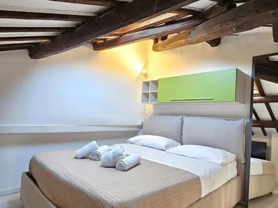 a bedroom with a large bed with white pillows at Apartment Wohnung Monserrato by Interhome in Rome