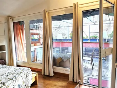 a bedroom with a bed and a large window at Apartment Wohnung Monserrato by Interhome in Rome