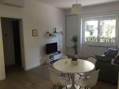 a living room with a table and a couch at Apartment GLI ARANCI Wohnung by Interhome in Rome