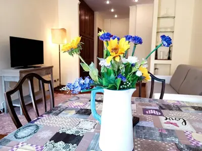 a vase filled with flowers sitting on a table at Apartment Rom-Ferienwohnungen - Case Vacanze Roma by Interhome in Rome