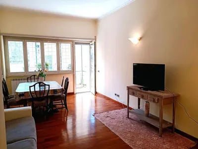a living room with a couch and a television on a table at Apartment Rom-Ferienwohnungen - Case Vacanze Roma by Interhome in Rome