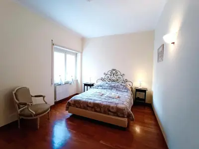 a bedroom with a bed and a chair and a window at Apartment Rom-Ferienwohnungen - Case Vacanze Roma by Interhome in Rome