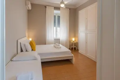 a bedroom with a white bed and a window at èROMA - ESQUILINO Apartment in Rome