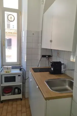 a kitchen with a sink and a counter top at èROMA - ESQUILINO Apartment in Rome