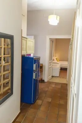 a kitchen with a blue refrigerator in a room at èROMA - ESQUILINO Apartment in Rome