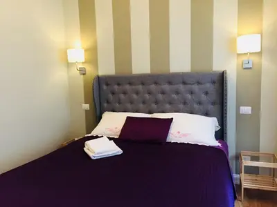 a bedroom with a large bed with two towels on it at FAIROME Apartment Cassia in Rome