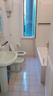 a bathroom with a sink and a toilet and a tub at Residenza Laterano in Rome