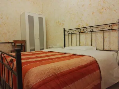 a bedroom with a bed and a mirror on the wall at Residenza Laterano in Rome