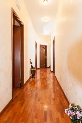 an empty hallway with wooden floors and white walls at Residenza Laterano in Rome