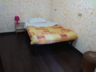 a small bedroom with a bed and a table at Residenza Laterano in Rome