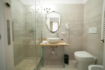 a bathroom with a shower and a sink and a toilet at Maison Coquette in Rome