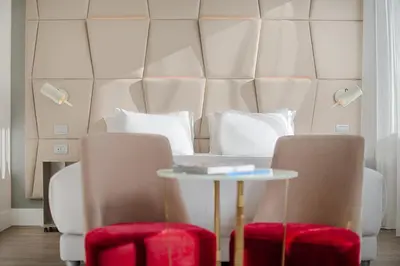 a living room with a table and two chairs at NH Collection Palazzo Cinquecento in Rome