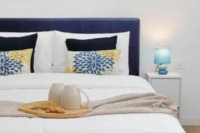 a blue and white bed with a tray of food on it at Ricky Bijoux by DomusDimore in Rome