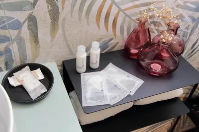 a table with two bottles ofodorizers on a table at Ricky Bijoux by DomusDimore in Rome