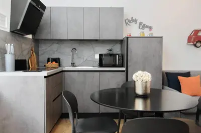 a kitchen with a table and a kitchen with a microwave at Ricky Bijoux by DomusDimore in Rome