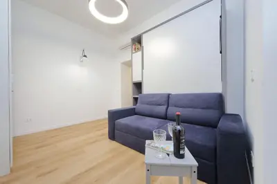 a living room with a blue couch and a table at 4BNB - Marmorata Urban Nest in Rome